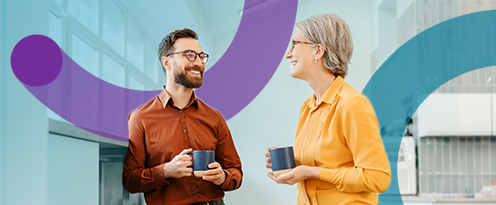 Man and woman having a chat with a cup of tea in their hands.
