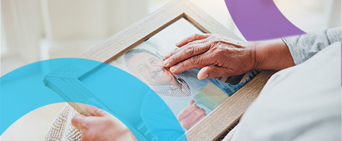 hand touching a picture of bereaved meber