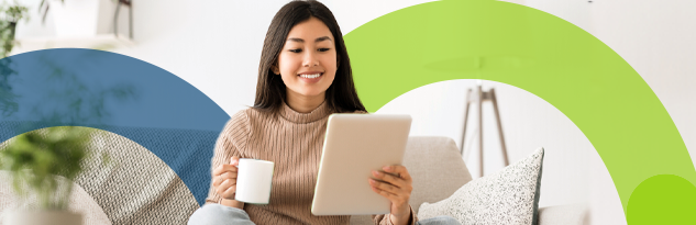 women sitting on couch on tablet and mug